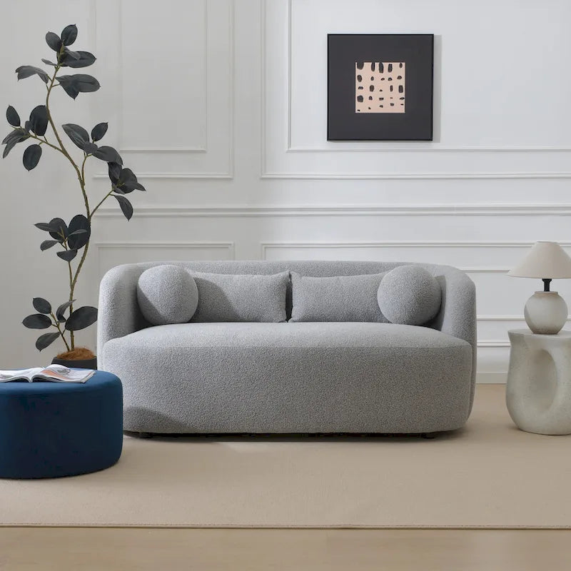 Causeuse 2 places en tissu bouclé avec oreillers