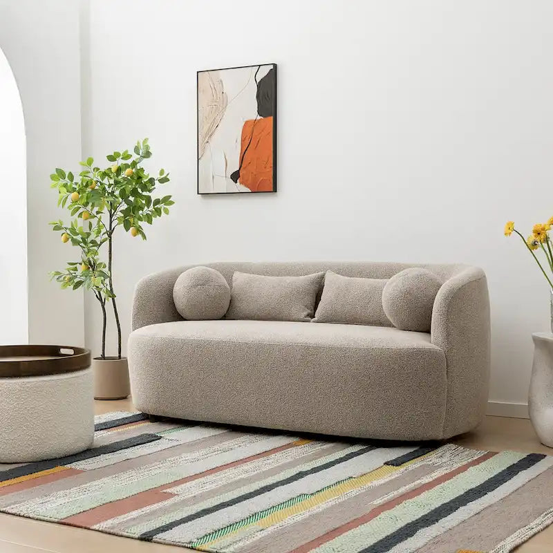 Causeuse 2 places en tissu bouclé avec oreillers