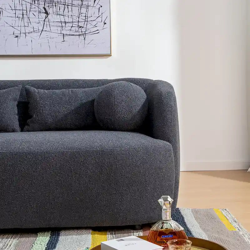 Causeuse 2 places en tissu bouclé avec oreillers
