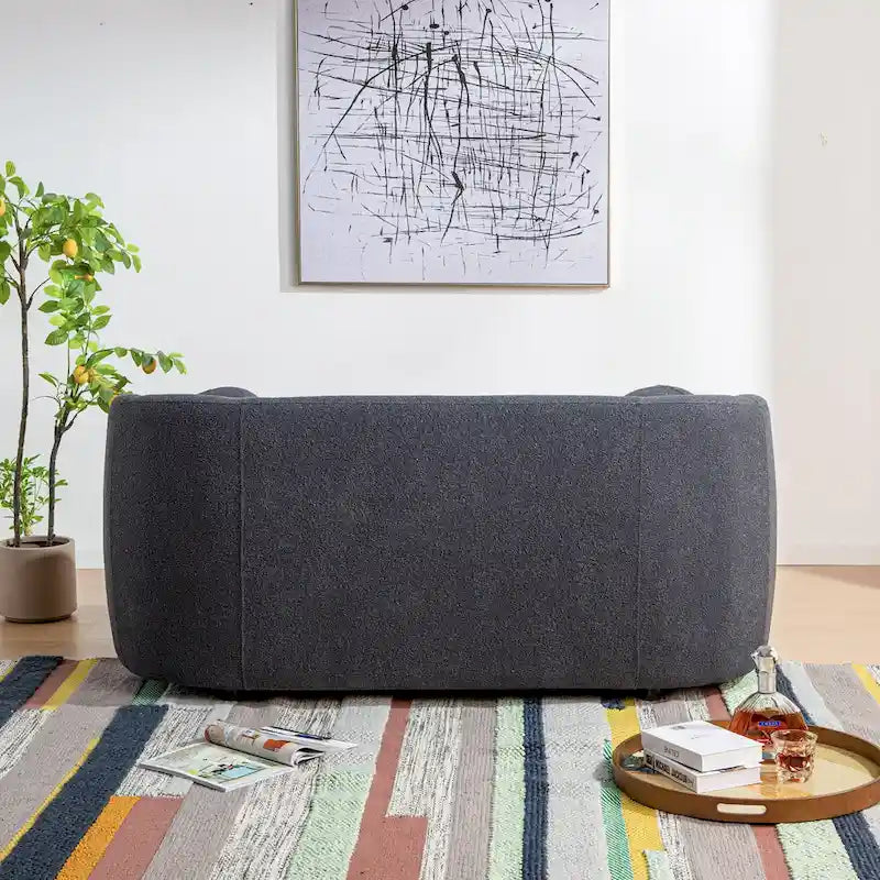 Causeuse 2 places en tissu bouclé avec oreillers