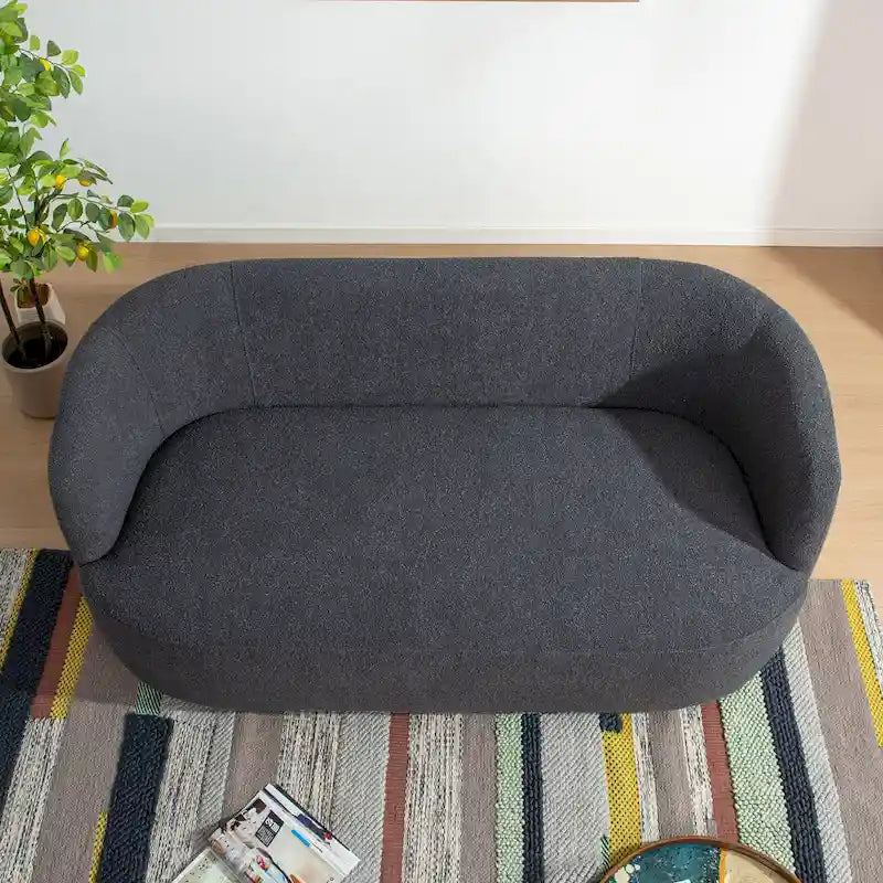 Causeuse 2 places en tissu bouclé avec oreillers