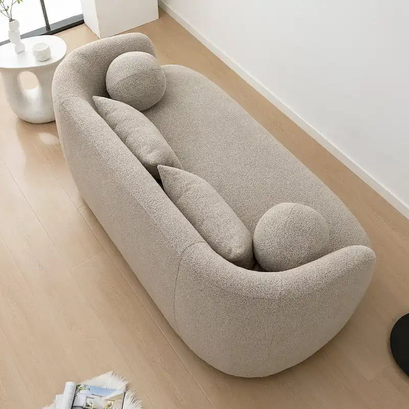 Causeuse 2 places en tissu bouclé avec oreillers